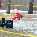 Children's toys were seen in the yard of a home in Carman surrounded in yellow police tape. (CBC)