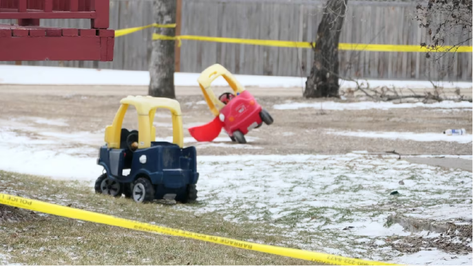 Children's toys were seen in the yard of a home in Carman surrounded in yellow police tape. (CBC)