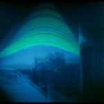 This image is a solargraph. It shows a view from a south-facing window on sixth floor of Fletcher Argue building. The green arcs trace a semester’s worth of the sun’s daily movement across the sky.