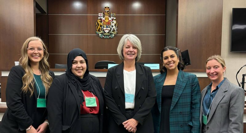 Team Manitoba for the 2024 Laskin Moot Competition left to right: Jayden Wlasichuk (3L); Zeynep Fattah (2L); Tanys Bjornson (coach); Maia Bacchus (2L); and Kirsten Nynych (2L) [Missing from the photo are researcher, Ashley Slagerman (3L) and coach, Tamara Edkins (Justice Manitoba)].