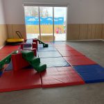 gym in the daycare centre with soft mats and play structure 