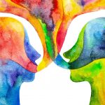 Watercolour painting of two heads facing each other with flowing language bubbles coming out of their mouths. Colours include blues, yellows, oranges, and reds.