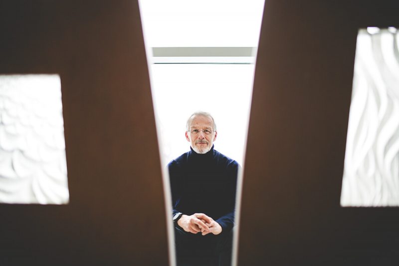 Researcher Ties Boerma is framed between two structural elements, sitting with his hands on his lap.