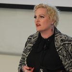 Stephanie Van Haute speaking at a conference.