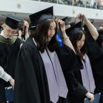 Graduating students move their tassels to the left at a convocation ceremony.