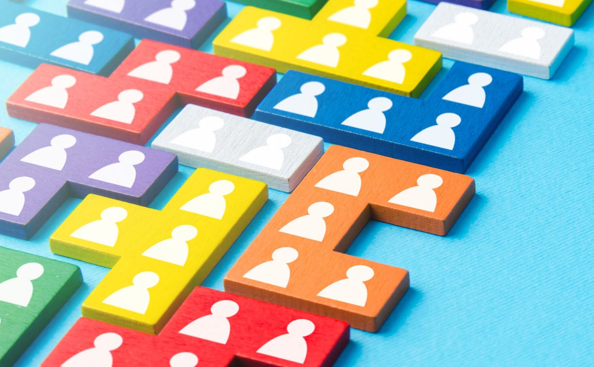 Image of different coloured puzzle pieces with person icon