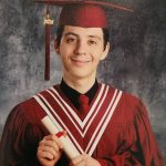 Larry Denisuik in his burgundy high school graduation cap and gown.