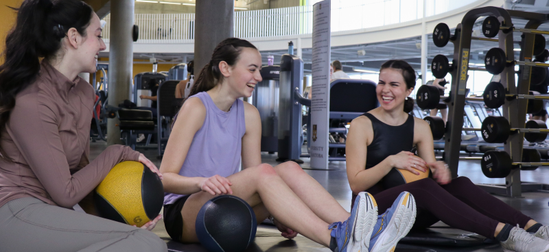 Three women in a gym.