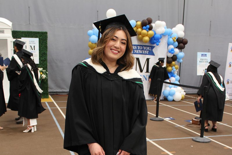 Eunice Custodio wearing her graduation cap and gown.