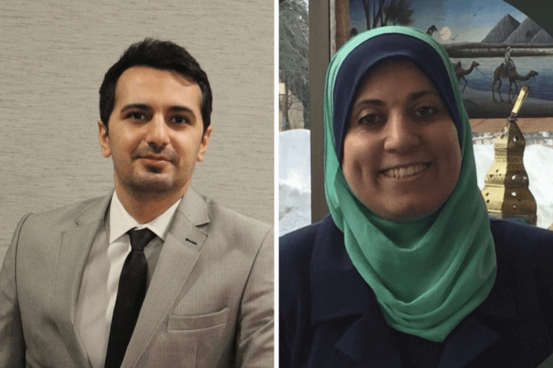 man with grey jacket and black tie; woman with green hijab both smiling