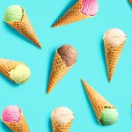 Various ice cream scoops in cones are scattered across a bright teal background