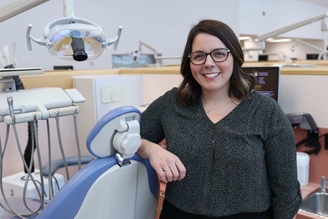 Kathy Yerex leans on a dental chair in the UM dental school's clinic.