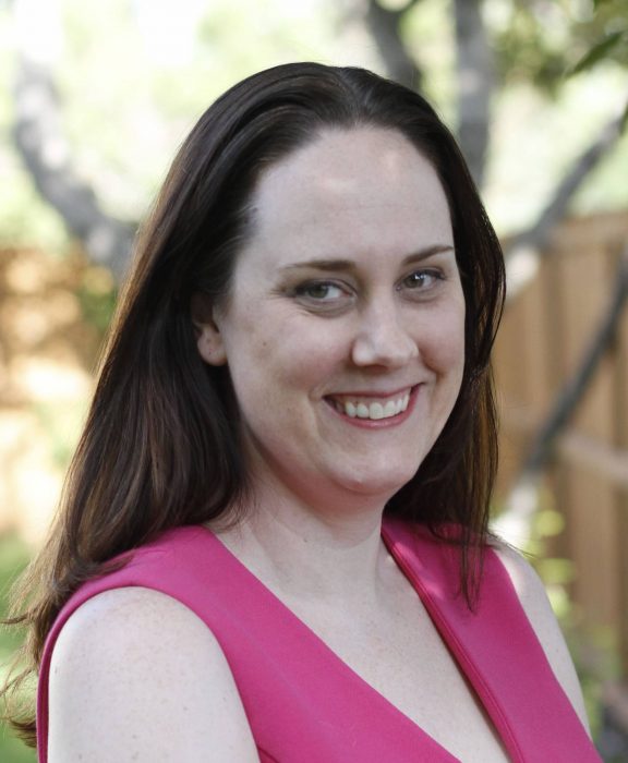 Photo of woman in pink smiling