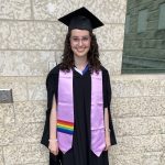 Chloe Vickar wears a lavender stole with Pride flag on it. She is also wearing a graduation cap and gown.