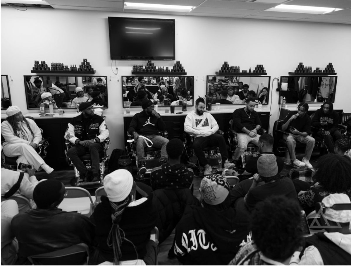 young people gather in a barber shop as part of an outreach workshop