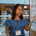 Camila Oda Jallime standing next to her research poster in brodie atrium