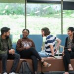 Students sitting on bench talking