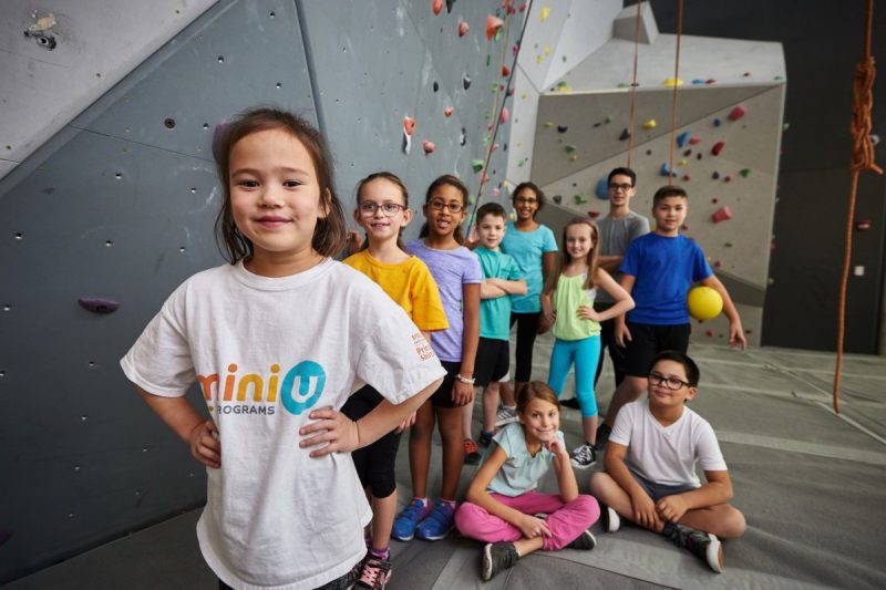 A Mini U camper standing in front of a group smiling