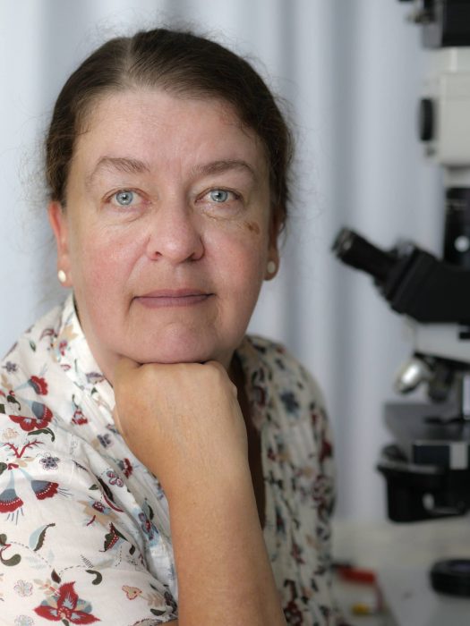 Dr. Sabine Mai poses with her microscope