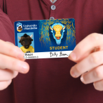 Student holding their ID card in front of them.