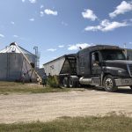 Grain truck loads a bin