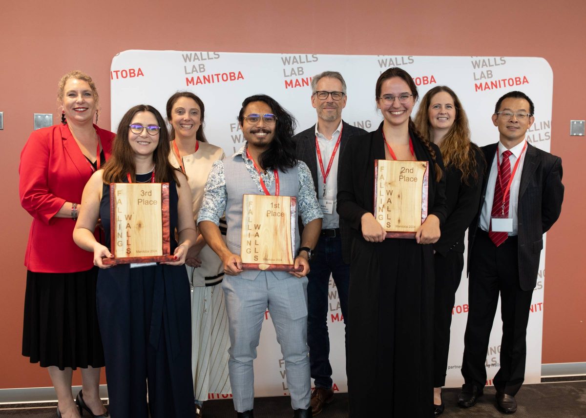 Winners and judges pose together with the Falling Walls Manitoba trophies.