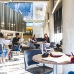 Students studying at desks in a public space