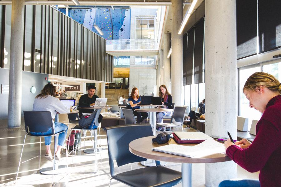 Students studying at desks in a public space