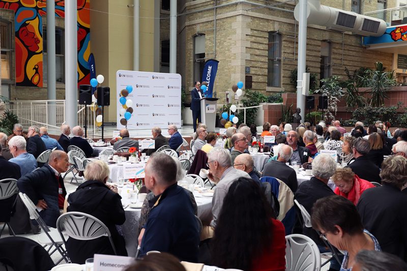 Dr. Peter Nickerson speaks to a large crowd gathered in the Brodie Centre atrium at Bannatyne campus.