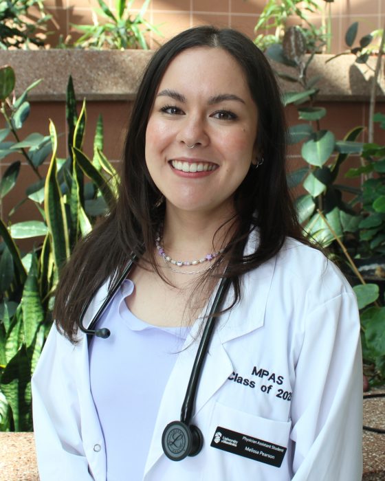 Portrait of Melissa Pearson. She is wearing a white coat and a stethoscope. 