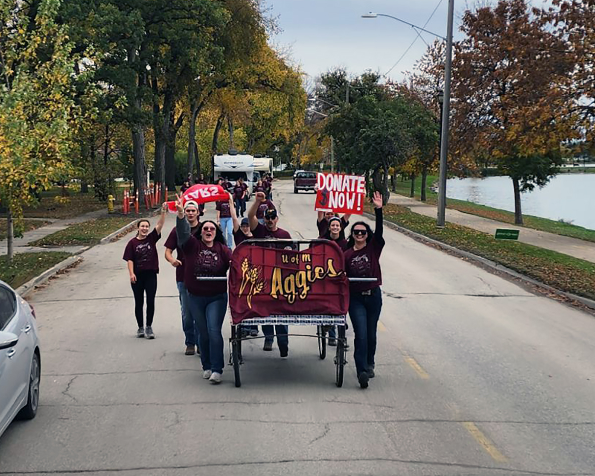 Aggie students push a bed for the 2024 campaign