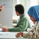 Two students learning in workshop.