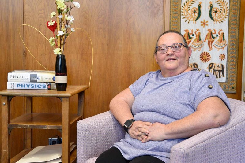 Susan Beshta sitting on a couch in the office.