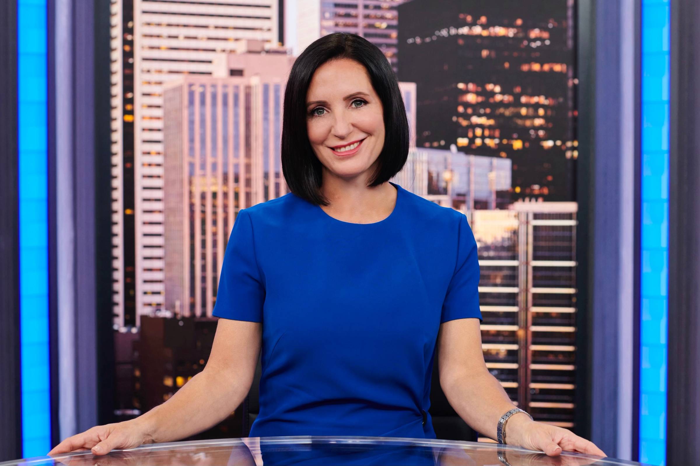 Amanda Lang sitting behind a news desk