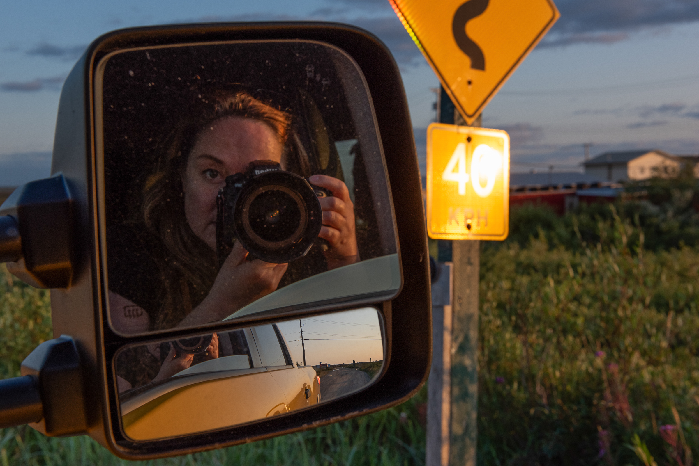 Katie Chalmers-Brooks looks through the camera from a pickup truck in Churchill