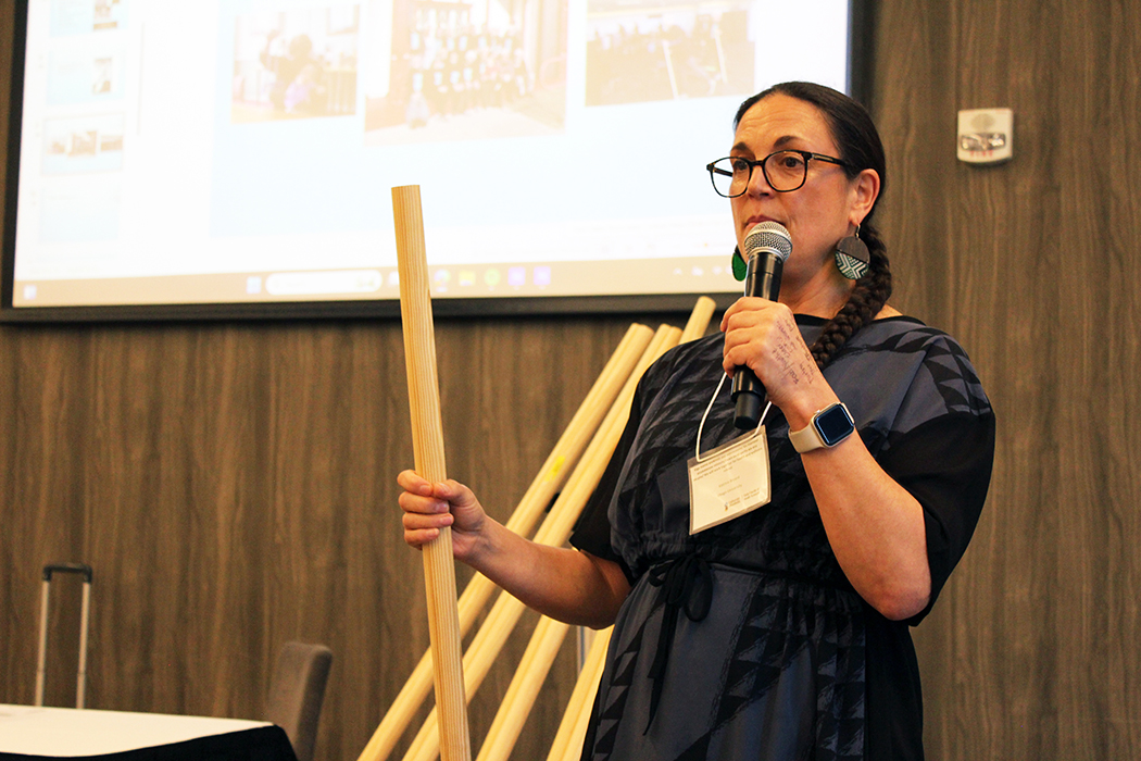 Katrina Pōtiki Bryant holds a balnce stick while leading a workshop on a wellness program she developed for Indigenous people in New Zealand.