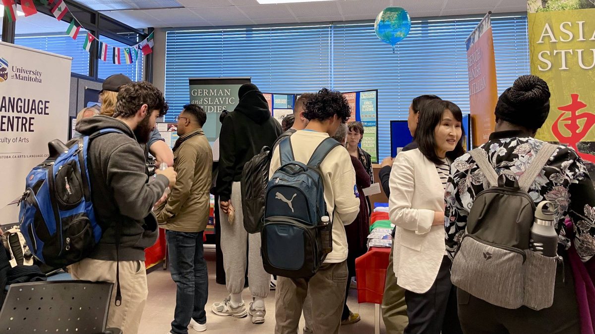 A group of students and instructors going booth to booth at an information fair.