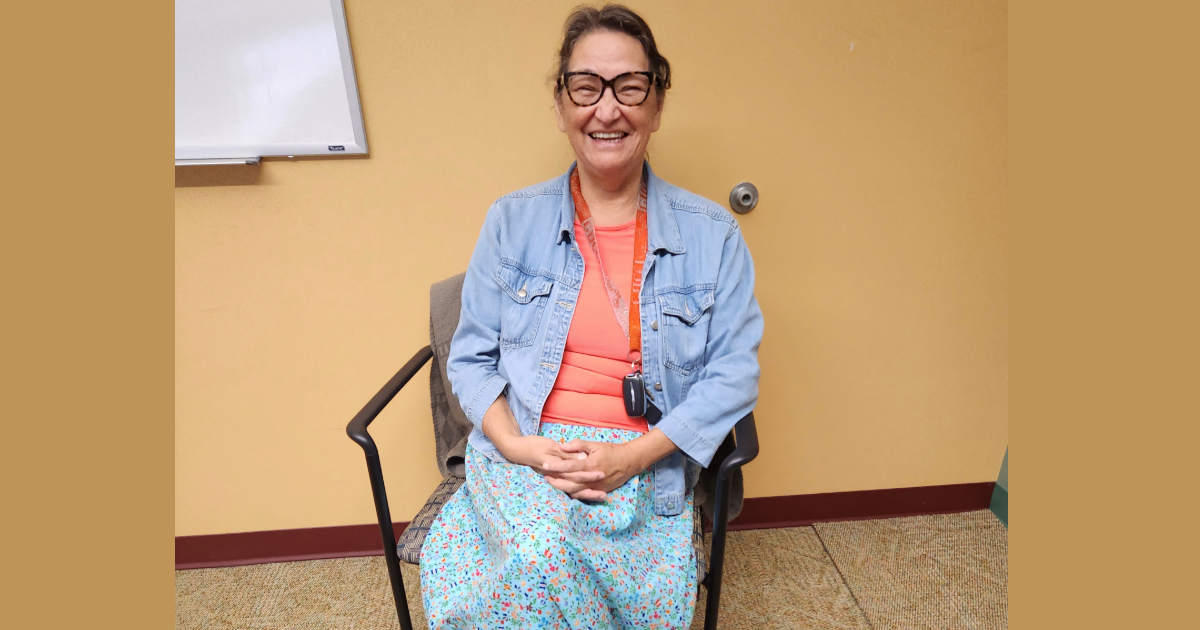 Photo of Karen Courchene sitting in an office in Migizii Agamik