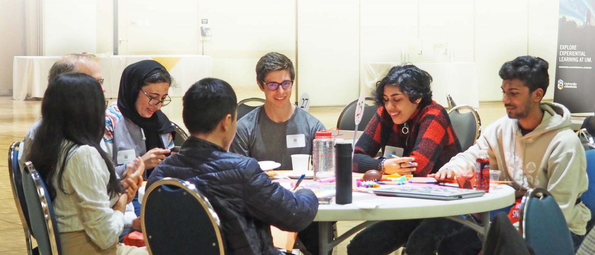 Workshop participants sit around a table.