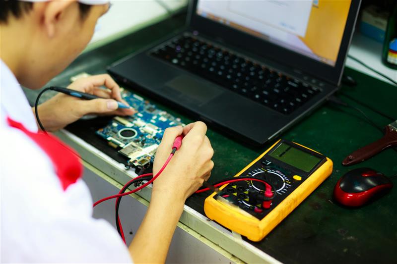 A student working on an electronics board.