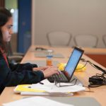 Student working on laptop at ALC Grad Writing Workshop