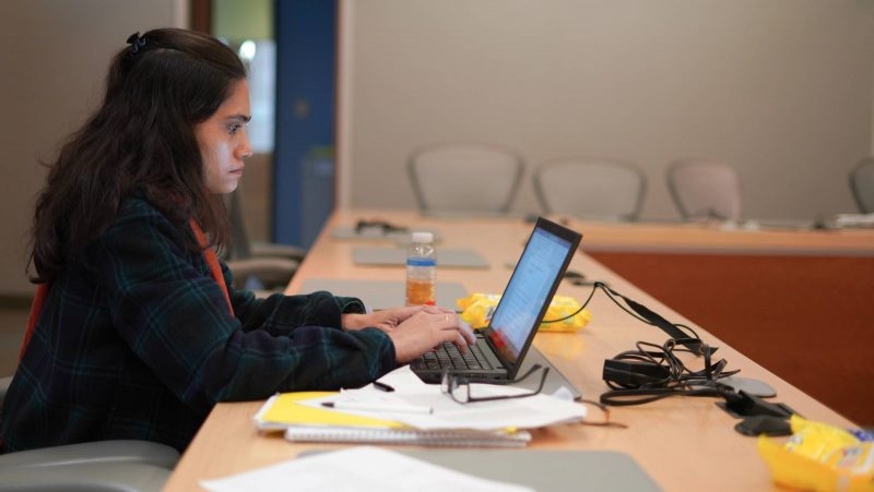 Student working on laptop at ALC Grad Writing Workshop