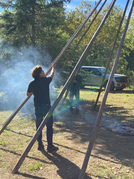 A student helps take down a structure at a sundance.