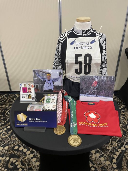 A collection of Brita Hall's memorabilia including skiing bib and medals