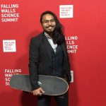 Nolan De Leon holds his signature skateboard on the red carpet at the Falling Walls Lab in Berlin.