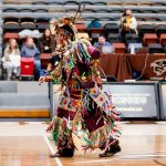 An Indigenous dancer performs in the Investor's Group Athletic Centre