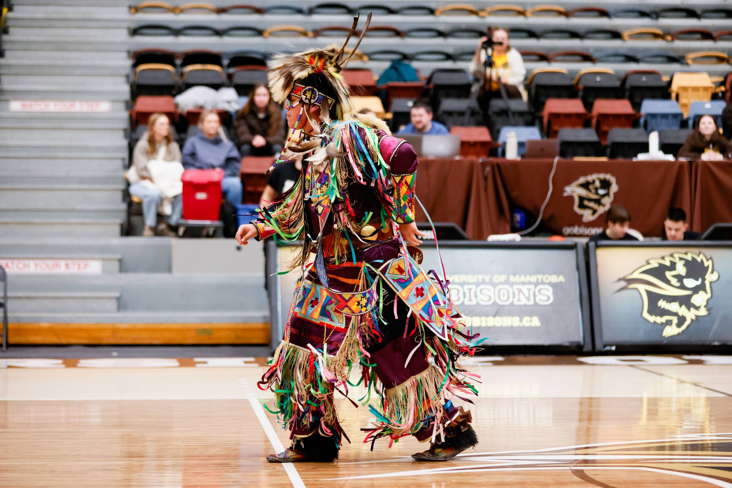 An Indigenous dancer performs in the Investor's Group Athletic Centre