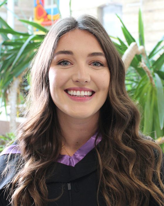 Mackenzie kozak wearing a convocation gown.