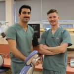 Two students pose for a photo in a dental clinic.