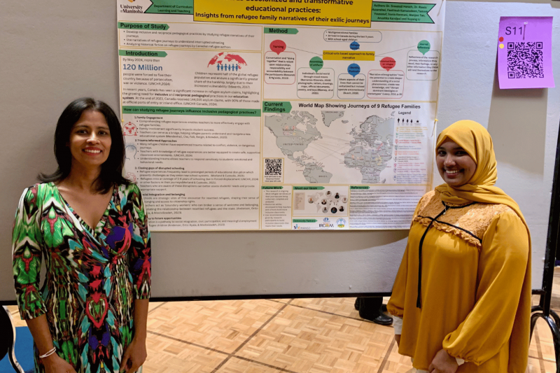 Student standing with research poster display. 